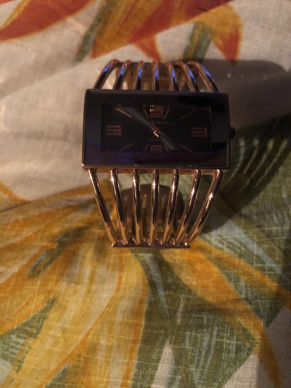 Gold and black watch with gold bar wrist cuff